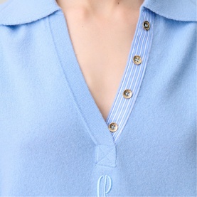 Model wearing Claude Pierlot Logo Polo Sweater in sky blue, showing gold-tone buttons, striped poplin placket, shirt collar and logo embroidery