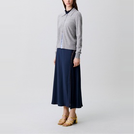 Model wearing Claude Pierlot Fine Knit Cardigan in mottled grey with shirt collar and button placket, styled with navy midi skirt and gold heeled