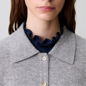 Model wearing Claude Pierlot Fine Knit Cardigan in mottled grey wool with shirt collar and front buttons, styled over navy ruffle-neck top.
