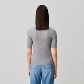 Model wearing Claude Pierlot Collar Knit Sweater in black, short sleeves, back view, styled with light blue jeans.