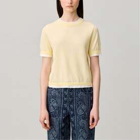 Model wearing Claude Pierlot Contrast Knit T-Shirt in clear yellow with scalloped trim, styled with dark paisley-print trousers