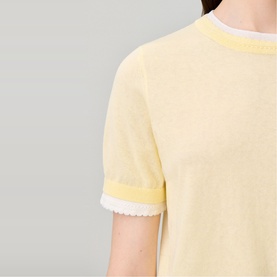 Model wearing Claude Pierlot Contrast Knit T-Shirt in clear yellow, showing scalloped cuff trim detail and layered knit texture at short sleeve.