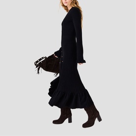 Model wearing Maje Womens French Dress in red, styled with dark suede knee-high boots and a fringed suede shoulder bag.