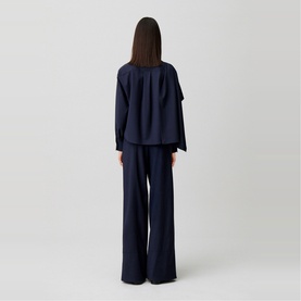 Model wearing Claude Pierlot Shawl Draped Jacket in blue, rear view, styled with matching wide-leg trousers