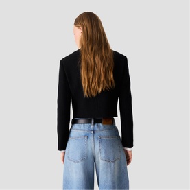 Model wearing Maje Womens French Dress in red, styled with light blue wide-leg jeans and a black belt, rear view.
