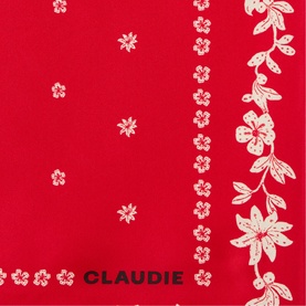 Red scarf with cream floral print border and scattered flower motifs, Claudie branding visible at hem