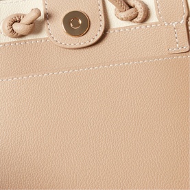Claude Pierlot bag in clear beige pebbled leather, close-up showing gold-tone snap button fastening and knotted strap detail