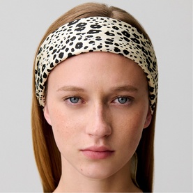 Model with cream and black leopard-print wide headband, worn across forehead, straight hair down