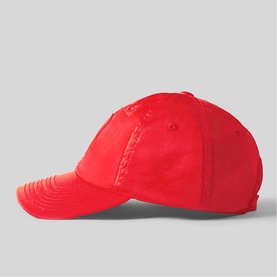 Claude Pierlot red cotton baseball cap with curved brim and eyelet vents, side profile view.
