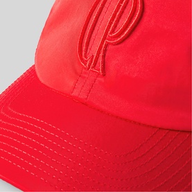 Claude Pierlot red satin baseball cap with tonal embroidered CP monogram logo on front panel, close-up detail shot