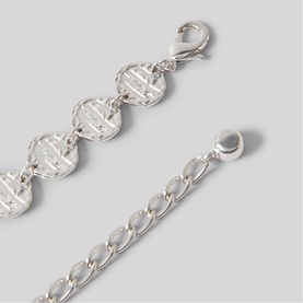 Silver-tone chain bracelet with engraved circular disc links and lobster clasp fastening, shown with extension chain detail