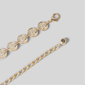Claude Pierlot metallic gold-tone bracelet with engraved disc links, lobster clasp fastening and curb chain extender.