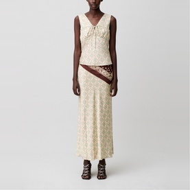 Model wearing cream floral sleeveless top and matching maxi skirt with contrast brown bandana-print panel, styled with brown lace-up sandals