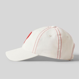 White baseball cap with red contrast stitching and embroidered heart detail, curved brim, side profile view
