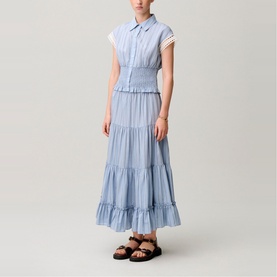 Model wearing Claude Pierlot light blue striped tiered maxi dress with collar and cap sleeves, styled with black strappy sandals