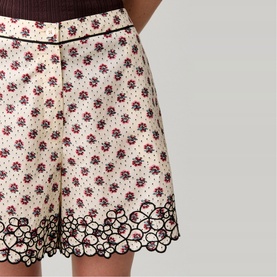 Claude Pierlot womenswear skirt in light print with floral and polka dot pattern, scalloped lace-effect hem trim in black and burgundy.