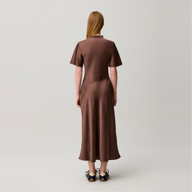Model wearing Claude Pierlot Womens French Dress in Brown Ice, short sleeves, satin midi length, back view, styled with black Mary Jane flats