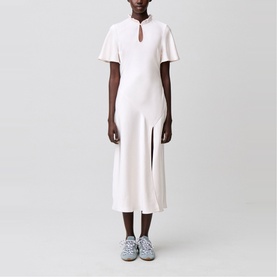 Model wearing Claude Pierlot Womens French Dress in clear white, midi length with flutter sleeves, keyhole neckline and front split, styled with blue