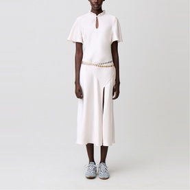 Model wearing Claude Pierlot Womens French Dress in clear white, styled with a chain belt and blue trainers