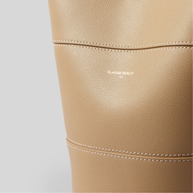 Claude Pierlot bucket bag in clear beige pebbled leather, close-up detail showing stitching and embossed logo