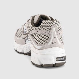 Nike trainer in college grey mesh and suede upper, white midsole with visible Air unit, grey rubber outsole, rear three-quarter view