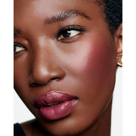 Model with Chanel Multi-Use Duo Stick in Pure Glow, showing rosy blush on cheeks and a mauve-pink tinted lip look
