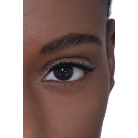 Model with Chanel 3-In-1 Eyeshadow-Eyeliner-Kohl Pencil in Baby Yellow applied to lower lash line, close-up eye shot