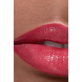 Chanel Hydrating Beautifying Tinted Lip Balm in Electric Vibe shown on lips, delivering a glossy, buildable deep pink tint
