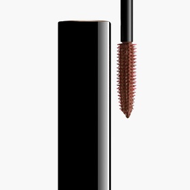 Chanel All-In-One Mascara in brown, showing sleek black tube with curved bristle wand extending volume, length, curl and definition.