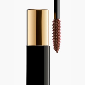 Chanel All-In-One Mascara in brown-bronze shade, black tube with gold cap, wand displayed showing spiky rubber bristles