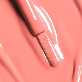 Chanel Longwear Nail Colour in Party Girl, coral-pink varnish swatch with brush applicator shown against pigment texture