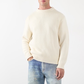 Model wearing Edwin Off White Baltic crew neck knit jumper, styled with light wash distressed jeans