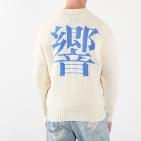 Model wearing Edwin Crew Neck in off white with large blue Japanese kanji graphic on back, paired with light blue jeans.