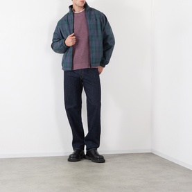 Model wearing Edwin Grape Nectar crew neck knit, styled with dark check jacket, navy jeans and black boots.