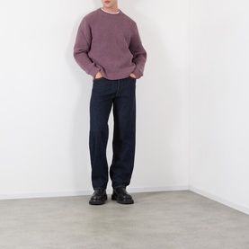 Model wearing Edwin 3049 Loose Jeans in blue rinsed, styled with a dusty pink knit and black leather shoes.