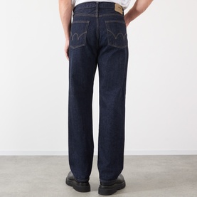 Model wearing Edwin 3049 Loose Jeans in blue rinsed, rear view showing straight-leg fit, back pockets with logo stitching