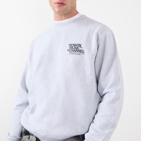Model wearing Edwin grey marl cotton sweatshirt with small chest logo graphic print, relaxed fit crew neck