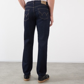 Model wearing Edwin 3049 Tapered Jeans in blue rinsed, rear view showing contrast stitching and classic back pockets.