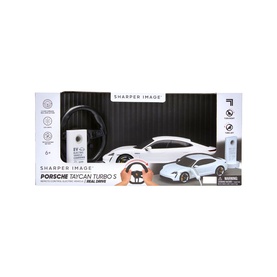 Sharper Image Porsche Taycan Turbo S RC Car in red, includes remote control and USB-C charging station, shown in packaging box