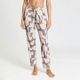 Model wearing Hanro PJ Pants in divided circles print, featuring a drawstring waist and relaxed straight-leg fit with side slits