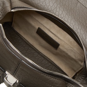Lemaire dark green leather bag interior, showing zip pocket, silver-tone zipper, and beige suede lining