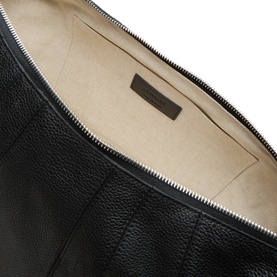 Lemaire Croissant Large Bag in black leather, interior view showing cream cotton lining, zip fastening, and embossed logo detail