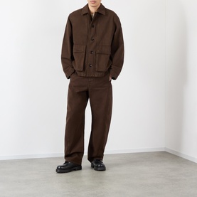 Model wearing Lemaire Flap Pocket Overshirt in brown with matching brown trousers and black chunky loafers.
