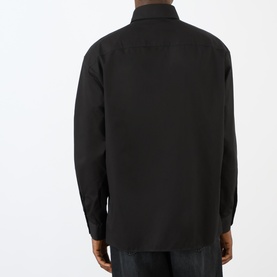 Model wearing Lemaire black casual shirt in 100% cotton, rear view showing relaxed fit and long sleeves