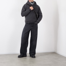Model wearing Lemaire dark grey cashmere hoodie, styled with black wide-leg trousers, crossbody bag and black loafers.