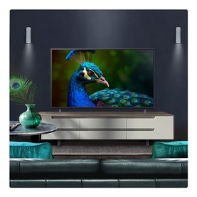 LG 50 Inch 4K UHD TV in black, displayed on a media unit in a styled living room showing a vibrant peacock on screen