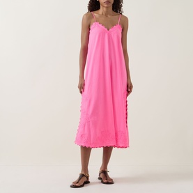 Model wearing Juliet Dunn Hot Pink cotton midi dress with scallop trim detailing and spaghetti straps, styled with tan flat sandals