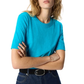 Model wearing Whistles blue crew neck short sleeve T-shirt, styled with dark denim jeans and black belt.