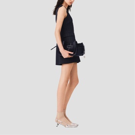 Model wearing Maje Womens French Dress in navy, styled with a small black crossbody bag and clear heeled mules.