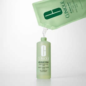 Clinique Liquid Facial Soap Mild Refill pouch dispensing into green pump bottle against white background
